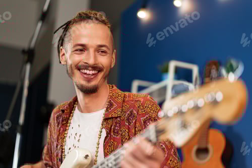Preview: Man Playing Electric Guitar in Home Studio