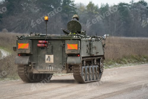 Preview: army tracked personnel carrier driving an unmade road