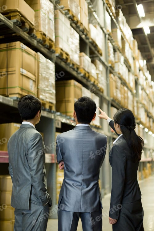 Preview: Business people talking in warehouse