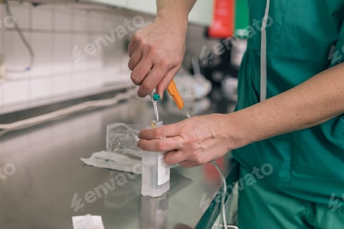 Preview: Medical Professional Preparing IV Drip in Hospital Setting