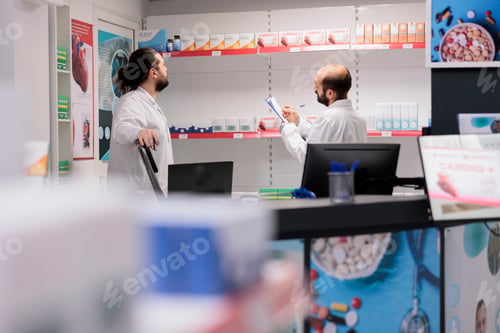Preview: Pharmacists in white coat maintains an inventory of all the different types of medicine and medical
