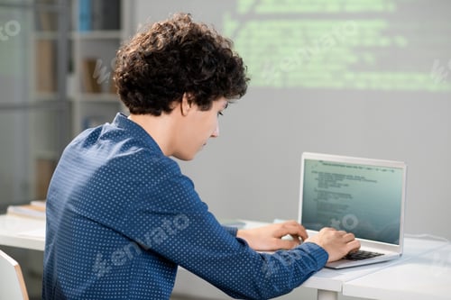 Preview: Serious clever student preparing presentation of his project for conference