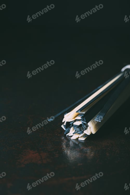 Preview: close up view of raw classical and black linguine pasta on black background