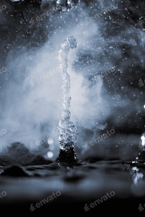 Preview: Boiling water splash with steam on black background closeup