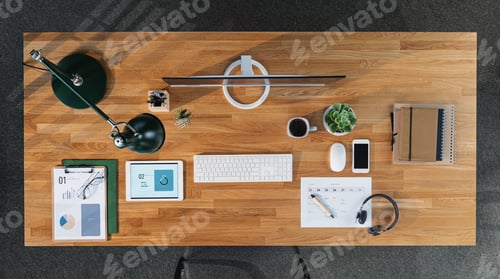 Preview: Top view of desk with computer, tablet and paperwork in home office.