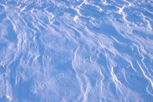 Preview: drawing on the surface of a snowy plain, created by the wind, illuminated by the setting sun
