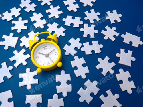 Preview: Yellow alarm clock and white puzzle on a blue background