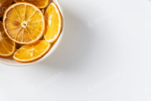 Preview: Dried Orange Slices in White Bowl on White
