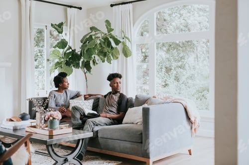 Preview: African couple chilling in a living room at home