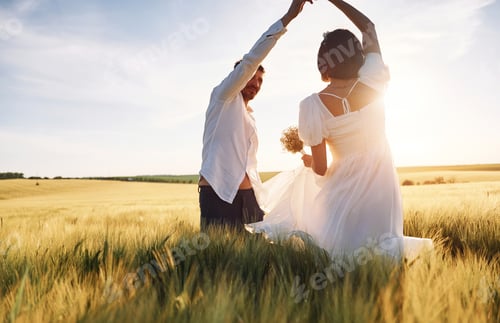 Preview: Against beautiful sunlight. Couple just married. Together on the majestic agricultural field