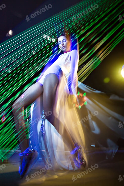 Preview: Fashion model in fashionable clothes in ultraviolet light