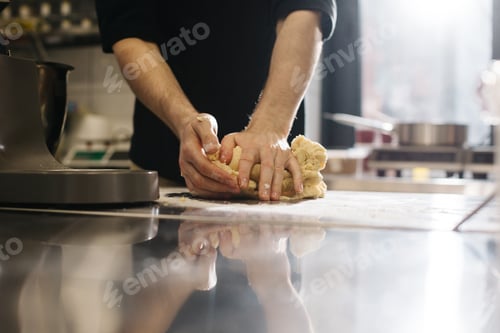 Preview: Close up. The cook kneads the dough with his hands, making macaroons or cakes.
