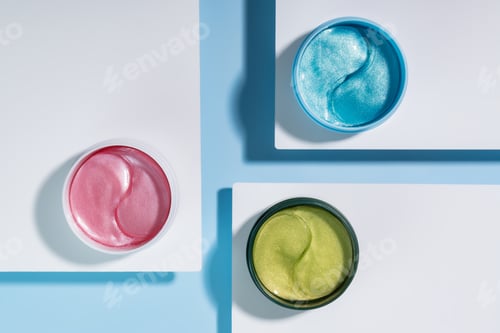 Preview: Hydrogel cosmetic eye patches for skin care on blue and white background. Product for skin lifting,