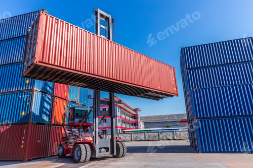 Preview: Truck forklift lifting loading heavy container cargo box at port container yard shipping logistics
