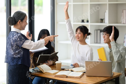 Preview: Smiling mature professor pointing at college student who wants to ask something during classroom