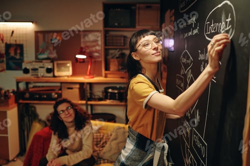 Preview: Woman drawing plan on blackboard
