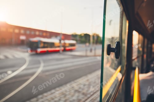 Preview: Bus of the public transportation at the sunset. Selective focus on the window of the tram.