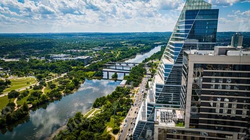Preview: Aerial view of Austin with modern buildings and green trees along the riverbank. Texas, USA
