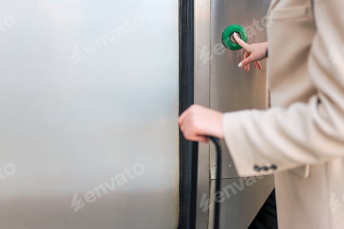 Preview: Woman presses button on the train door to enter. Railway trip concept