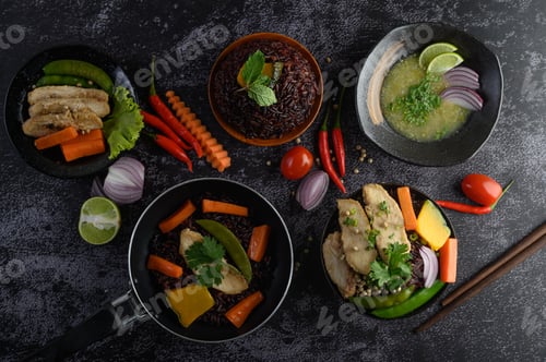 Preview: Assorted food and dishes of vegetables, meat and fish on a black stone background. Top view.