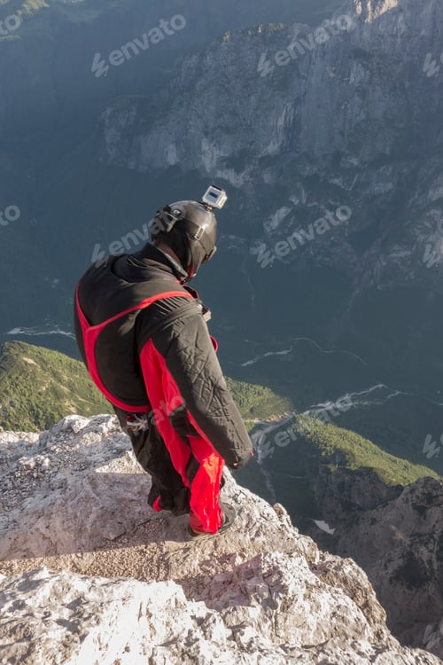 Preview: BASE jumper on mountain edge, Alleghe, Dolomites, Italy