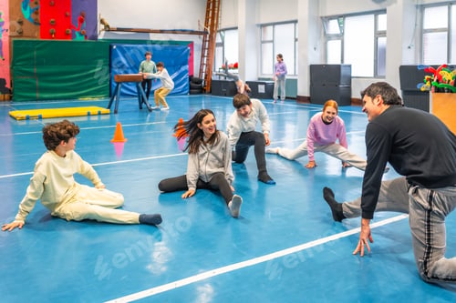 Preview: Students stretching with teacher in school gym class