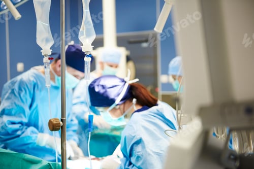 Preview: Intravenous drip and busy surgeons in the background