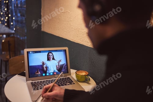 Preview: Male studing online with laptop in cafe