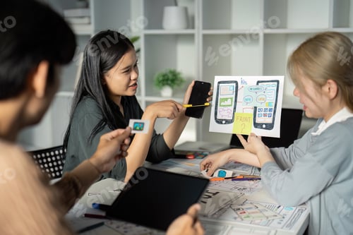 Preview: Creative UX UI Design Team Brainstorming Session with Digital Devices and Wireframes in Modern