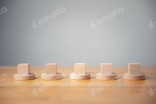 Preview: Five wooden blocks on round bases, arranged in a line on a wooden table. Minimalist, clean, and