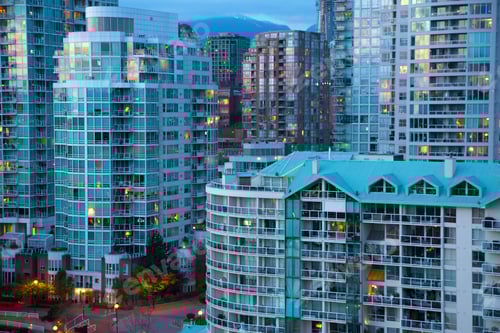 Preview: Cityscape with illuminated skyscrapers and apartment buildings.