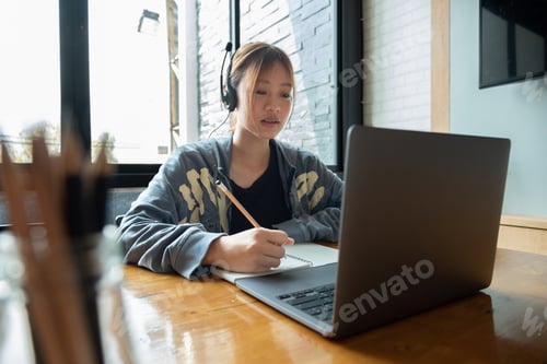 Preview: Cropped photo of asian woman writing making list taking notes in notepad working or learning on