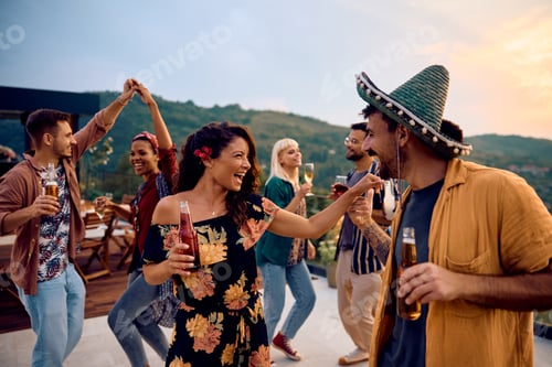 Preview: Carefree woman having fun while dancing with friends on summer party outdoors.