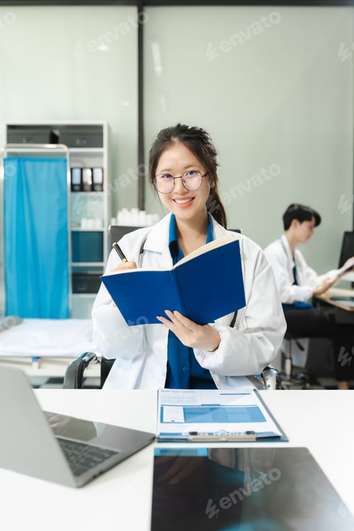 Preview: Successful female doctor standing at table, looking at camera.