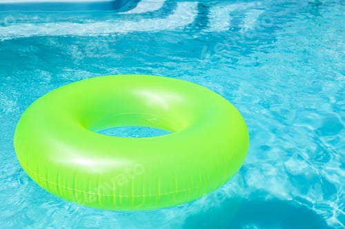 Preview: Bright inflatable ring floating in swimming pool on sunny day