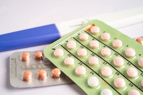 Preview: Pregnancy test and birth control pills on calendar, contraception health and medicine.