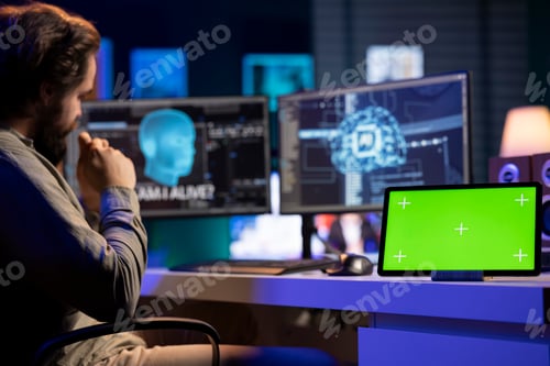 Preview: Chroma key tablet on desk next to self aware artificial intelligence