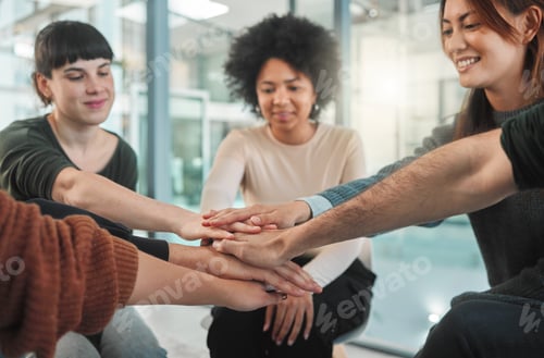 Preview: Happiness begins here. Shot of people stacking their hands during a group therapy session.