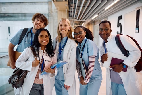 Preview: Multiracial group of happy medical students at the university looking at camera.