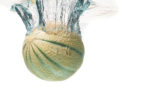 Preview: Cantaloupe melon splash and sinking isolated against white