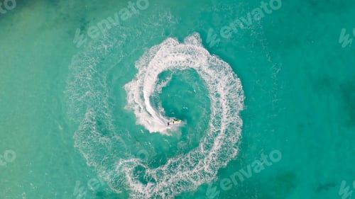 Preview: Jet ski or boat drawing a shape on sea ocean turquoise water. Adventure extreme recreation activity.
