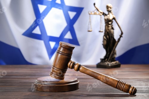 Preview: Judge's gavel and statue of Lady Justice on wooden table against flag of Israel, closeup