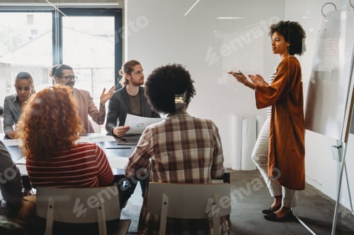 Preview: Happy african american female leader holding negotiations meeting with friendly diverse colleague