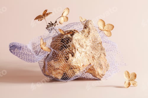 Preview: stone in mesh bag with dry flowers on beige background. art, stylish concept.