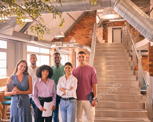 Preview: Portrait Of Smiling Multi-Cultural Business Team In Modern Open Plan Office Together