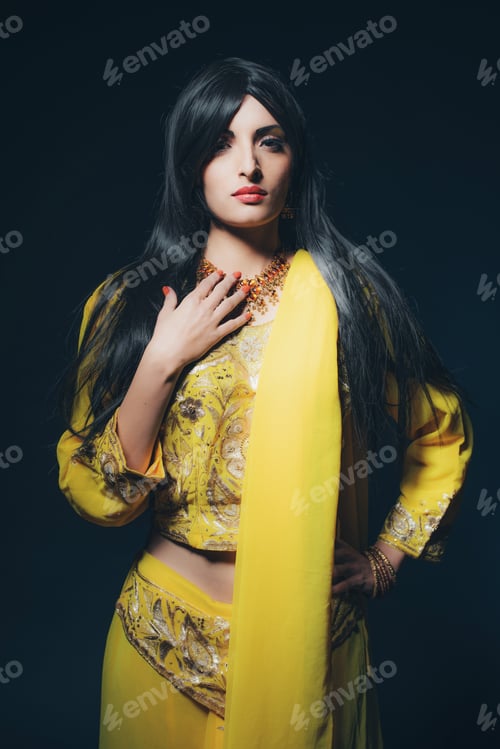 Preview: Vintage Bollywood Fashion Girl In Yellow Clothes Against Dark Blue Background.