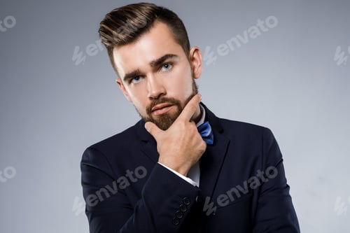 Preview: Stylish handsome man wearing a classic suit with bow-tie