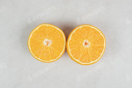 Preview: Half cut juicy orange on gray background