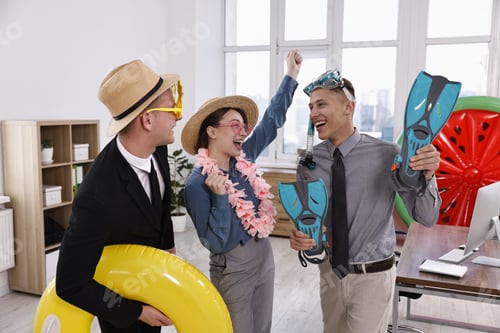 Preview: Colleagues with different beach accessories having fun in office