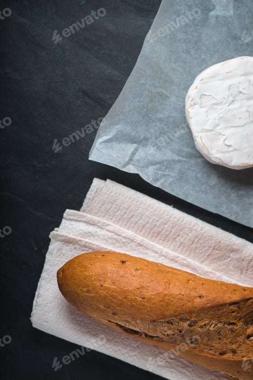 Preview: Brie cheese with bread on the stone background